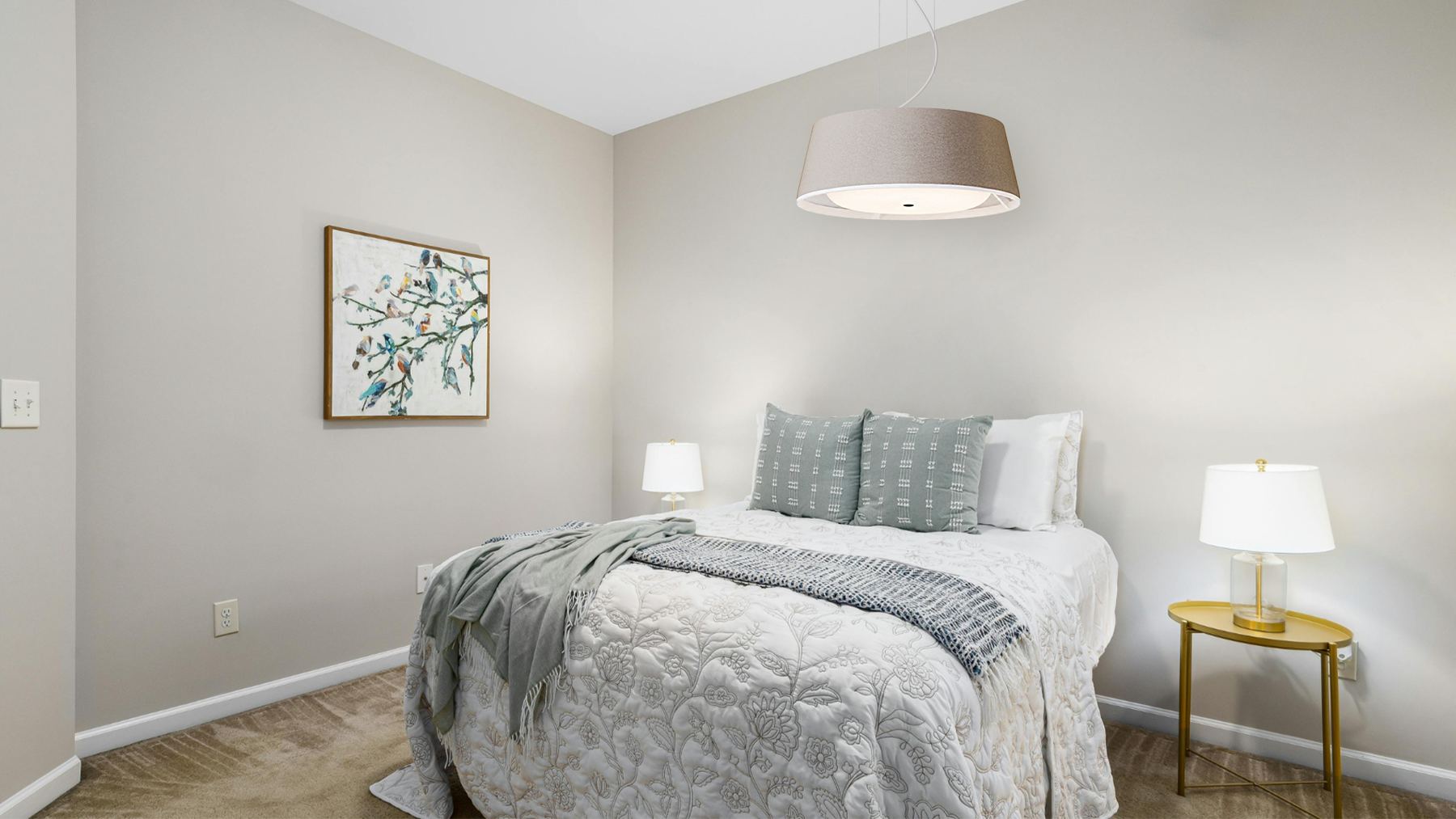A resident's bedroom with a Nobi Pendant light above the bed.